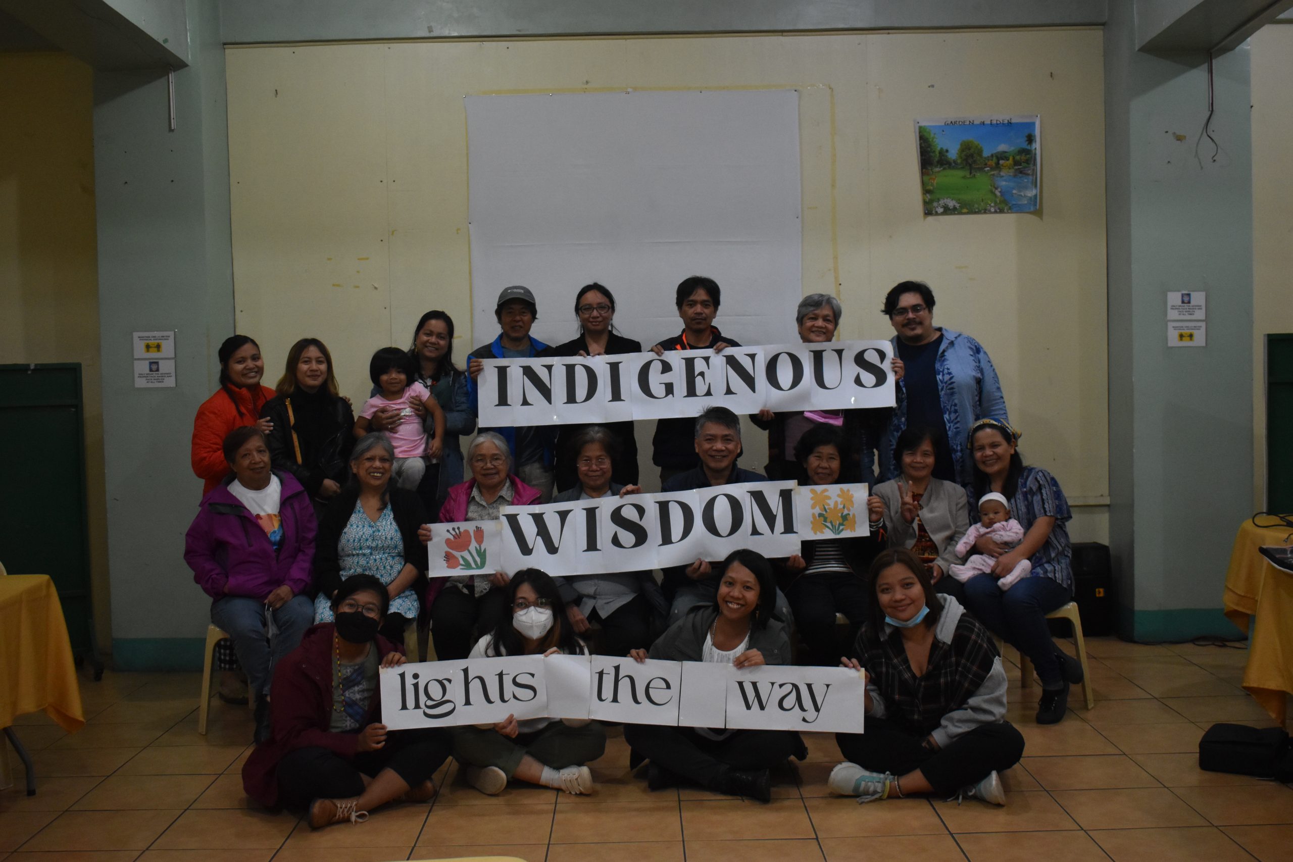 PIKP staff and partners hold up together a sign saying ‘Indigenous Wisdom Lights the Way’ after successfully completing the inception workshop for the Transformative Pathways project held in Baguio City, Philippines.