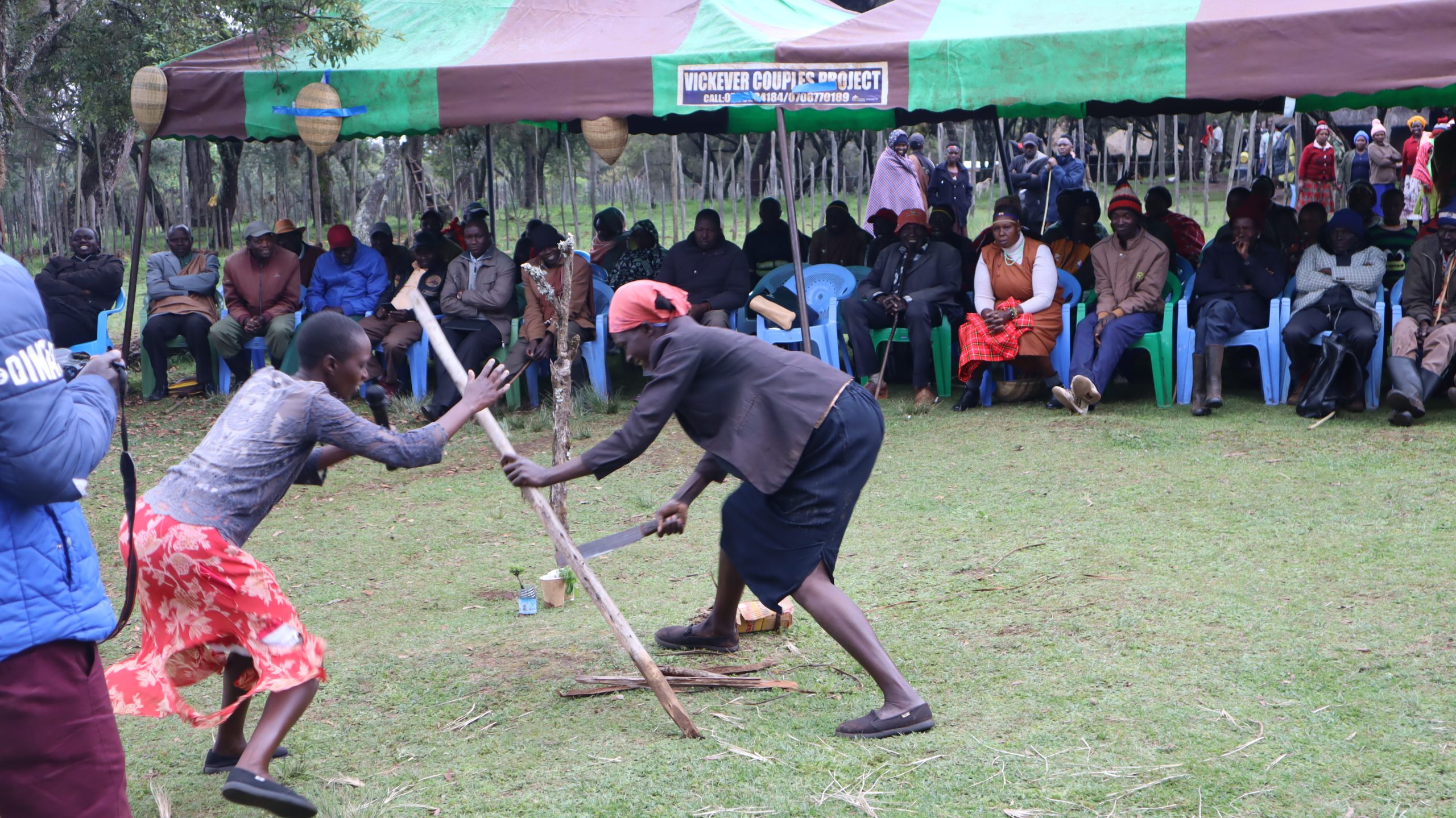 Women perform a skit to discourage deforestation.